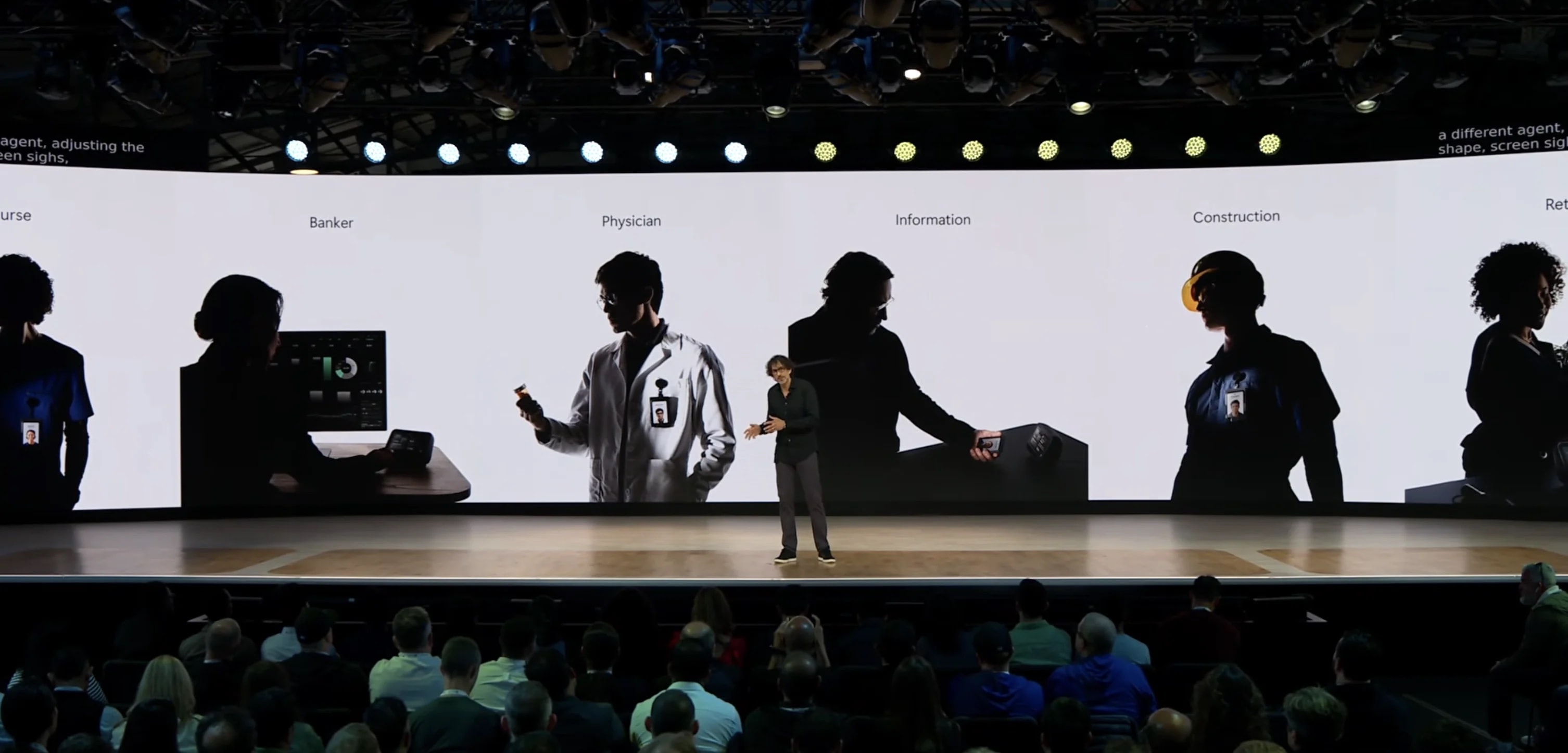 The Build 2026 keynote stage: a wide screen showing silhouetted workers labelled Nurse, Banker, Physician, Information, Construction, and Retail, each wearing a Solara badge